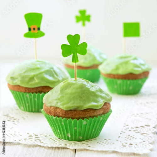 Homemade green cookies with shamrock flag on a table