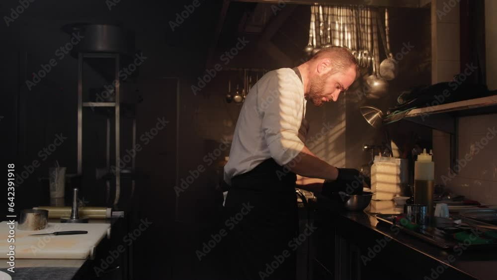 Cook prepare the breakfast in a stellar restaurant kitchen at sunrise Cook prepare the breakfast in a stellar restaurant kitchen at sunrise