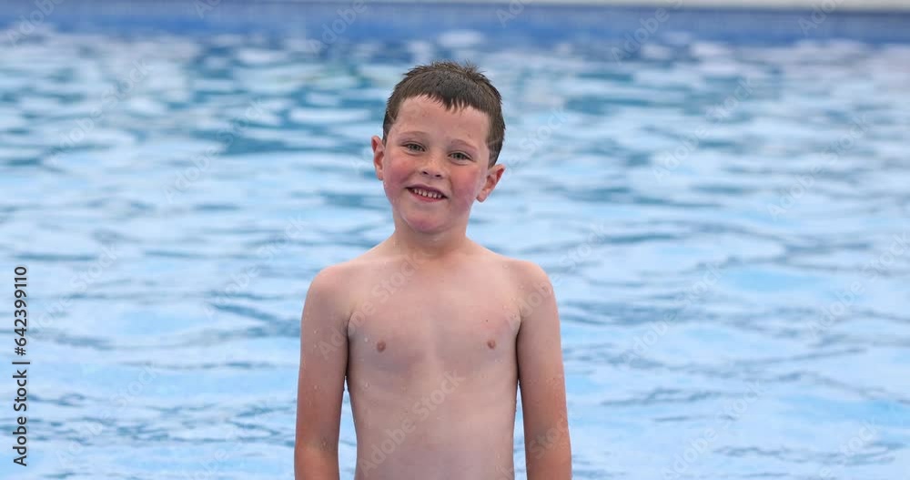 Cheerful cute kid standing in swimming pool Cheerful cute kid standing in swimming pool