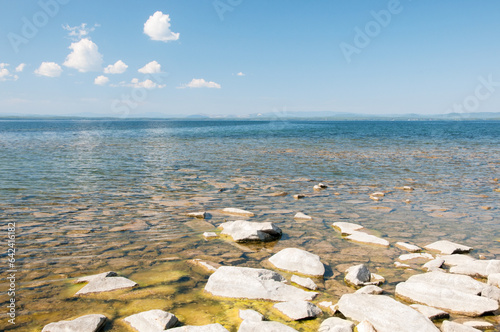 Seascape view of Uvildy lake with its stony shoreline in summer, South Urals, Russian Federation photo
