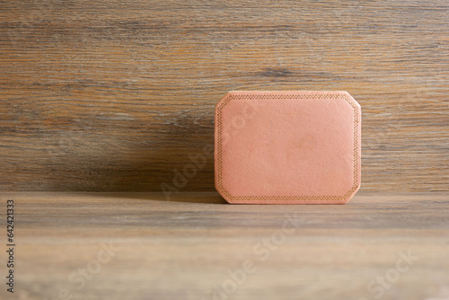 Pink jewelry box on wooden background