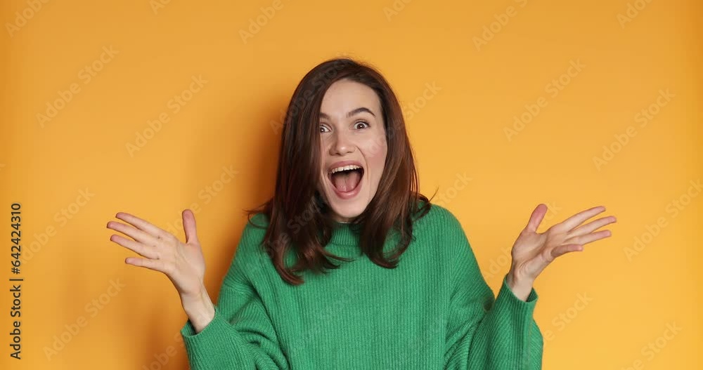 Amazed excited woman hairstyle in sweater look surprise looking at camera with big eyes, shocked. Indoor studio shot isolated on yellow background. Oh my god wow! Amazed excited woman hairstyle in sweater look surprise looking at camera with big eyes, shocked. Indoor studio shot isolated on yellow background. Oh my god wow!