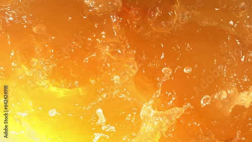 Super Slow Motion Shot of Fresh Peaches Falling into Juice Whirl