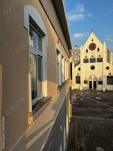 A side-view of an european-style building and a church-like wedding hall nearby in Nanshan district of Shenzhen, China photo