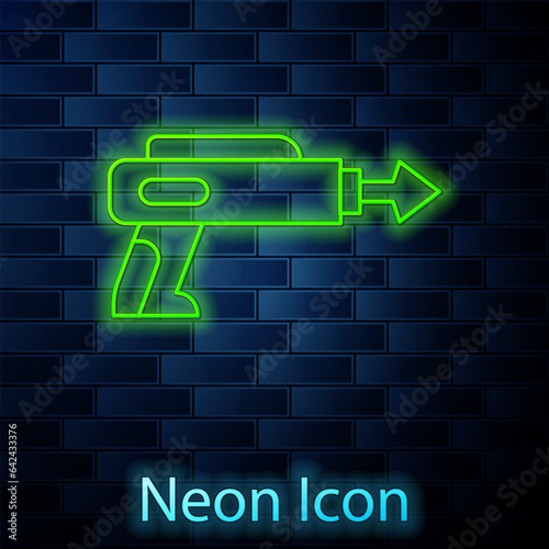 Glowing neon line Fishing harpoon icon isolated on brick wall background. Fishery manufacturers for catching fish under water. Diving underwater equipment. Vector