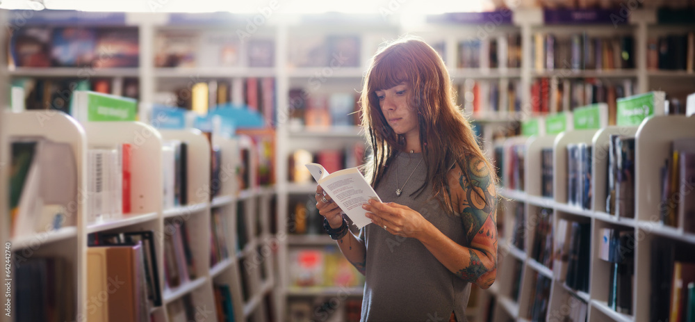 Web banner of shopping books. Side view of pretty Caucasian woman with tattoo reading book in bookstore. Copy space. Concept of education and Book Day