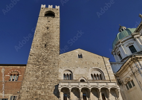 Facades of old town hall Broletto, tower Torre del Pegol, medieval house Loggia delle Grida and cathedral of Brescia in square Piazza Paolo VI. photo