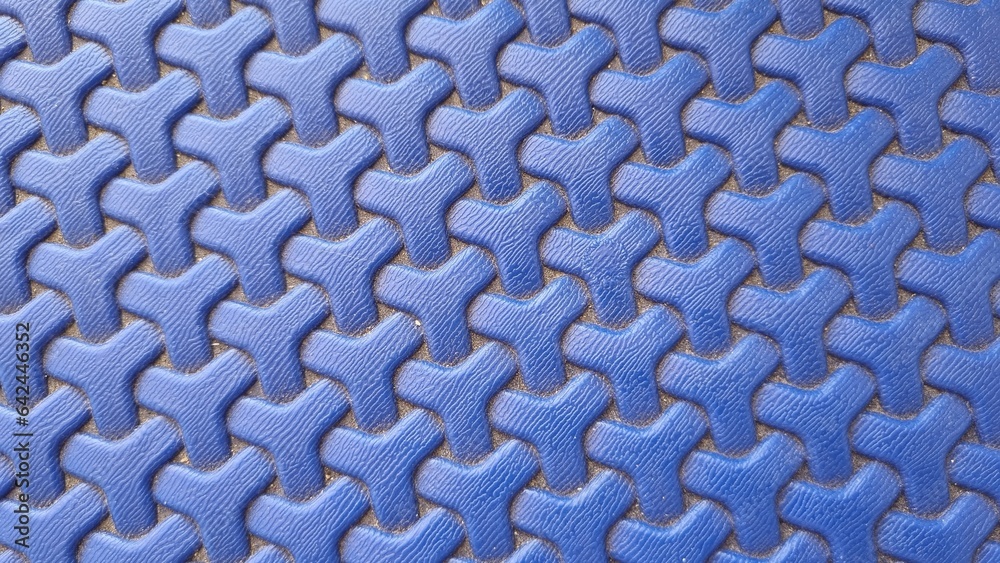 Plastic weave pattern background. Zigzag interlocking of symmetrical shapes. Blue woven background. Plastic weave pattern background. Zigzag interlocking of symmetrical shapes. Blue woven background.