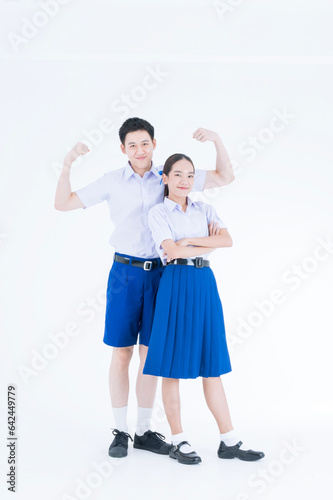 Healthy school children. Asian girl and boy in students uniform on white background. © Thirawatana