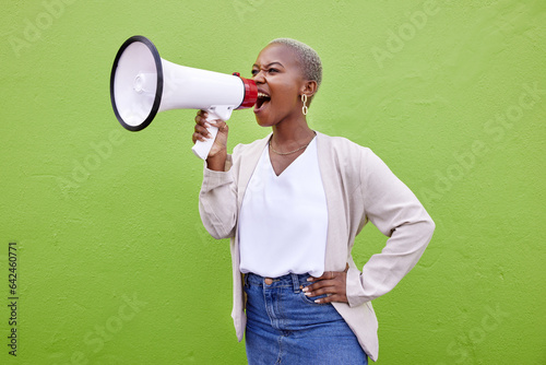 Black woman, megaphone and screaming on mockup space in advertising or protest against a studio background. African female person screaming in bullhorn or loudspeaker for sale discount, vote or alert photo