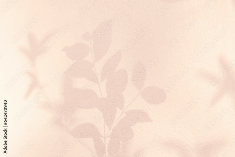 Shadow and light of leaves tree branch background. Natural  colorful leaf pastel pink, beige, rose gold shadow and light from sunlight on white wall texture for wallpaper overlay effect and design