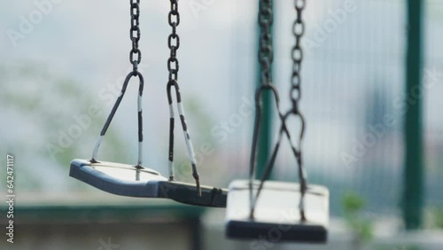 Two Old Abandoned Swings Swaying in the Breeze
