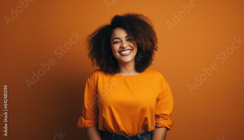 happy latin woman in oranhe color sweater laughing