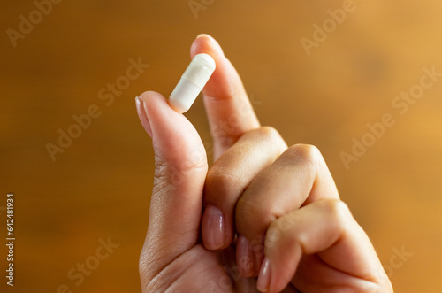 Tablet held in hand, dietary supplement, body support, medicine to improve health, tablet dosage