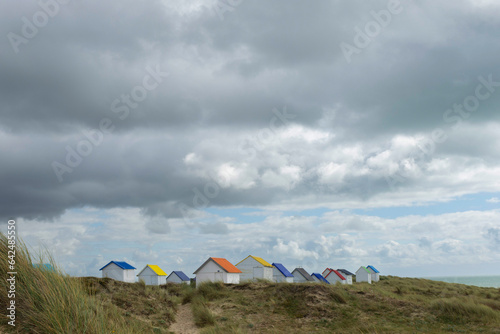 Beach cabins and seashore in Gouville sur Mer, Manche, Normandy, France in various lights photo