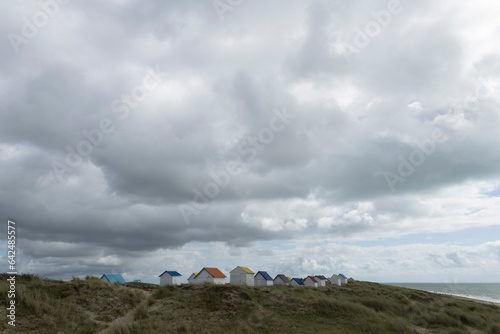 Beach cabins and seashore in Gouville sur Mer, Manche, Normandy, France in various lights photo