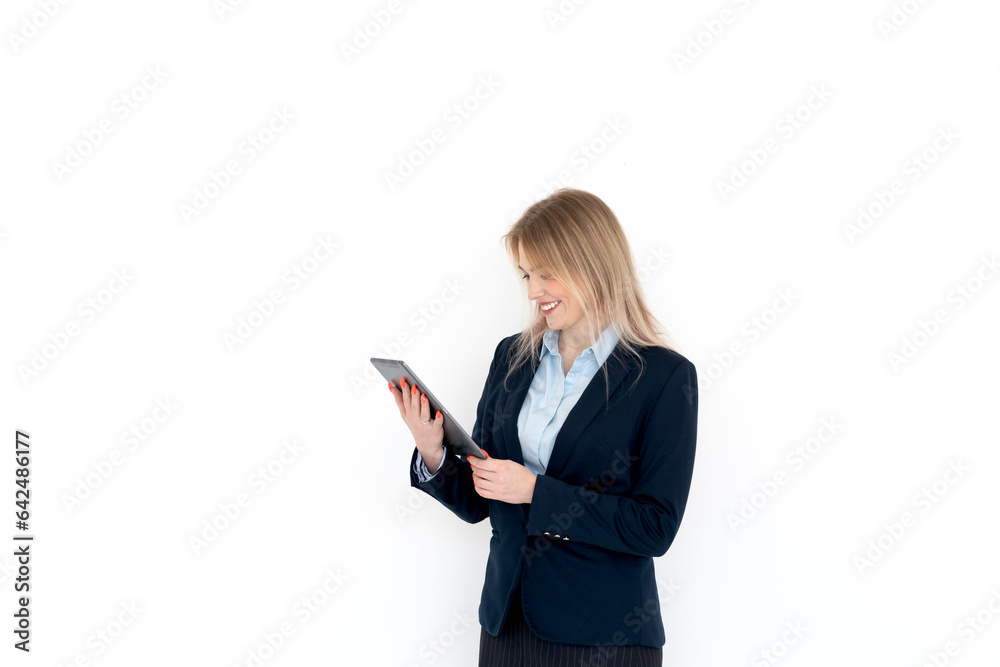 Young attractive and smiling business woman in black suit holding gadget isolated on white. Copy space and place for text concept Young attractive and smiling business woman in black suit holding gadget isolated on white. Copy space and place for text concept