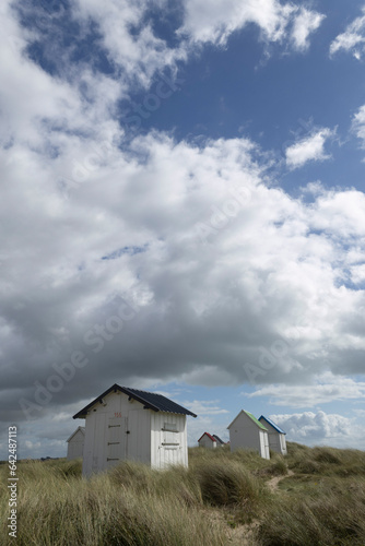 Beach cabins and seashore in Gouville sur Mer, Manche, Normandy, France in various lights © denis