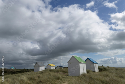 Beach cabins and seashore in Gouville sur Mer, Manche, Normandy, France in various lights photo