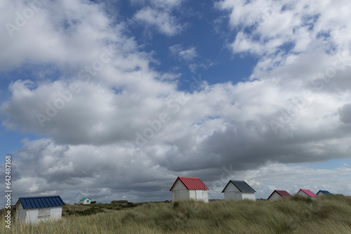 Beach cabins and seashore in Gouville sur Mer, Manche, Normandy, France in various lights