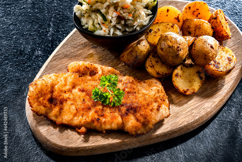 Chicken cutlet coated with breadcrumbs with potatoes and cabbage