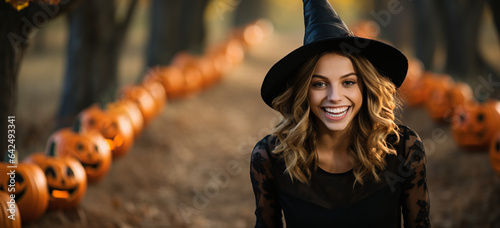 portrait of a girl in a park with halloween decoration on witch costume