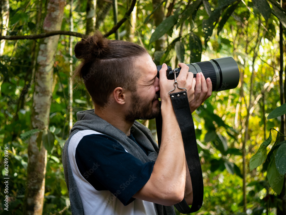 Young White Photographer Tries to Take Picture of Birds in the Middle of Nature Young White Photographer Tries to Take Picture of Birds in the Middle of Nature