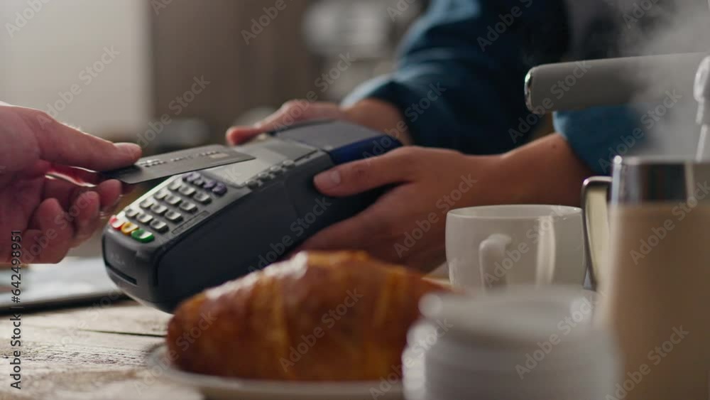 Barista. Master barista paying online with a credit bank card in the