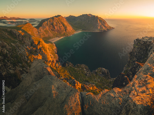 Sunset on Ryten mountain with Kvalvika beach view during sunset on Lofoten ultra wide panorama high quality 