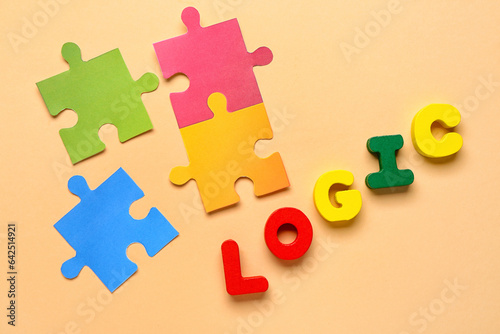 Word LOGIC with paper puzzle pieces on beige background