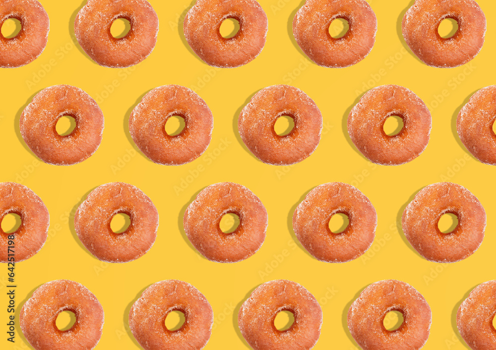 Creative pattern donuts flat lay on pastel yellow background. Minimal sweet food concept. Surreal original donuts cake top view for bakery. - obrazy, fototapety, plakaty 