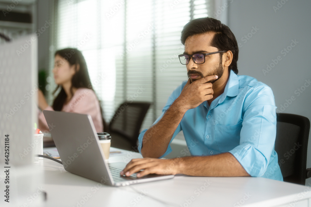 Serious Islamic Businessman Working on Laptop in Corporate Office. Serious Islamic Businessman Working on Laptop in Corporate Office.