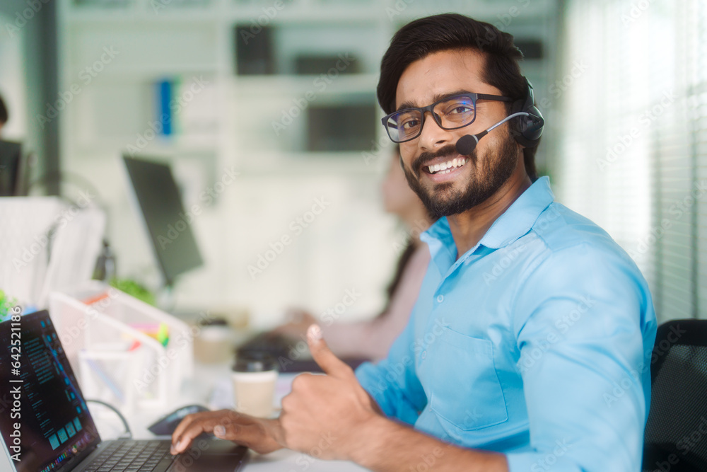 portrait of an Islamic man service agent with headphones smiling and looking at the camera. portrait of an Islamic man service agent with headphones smiling and looking at the camera.