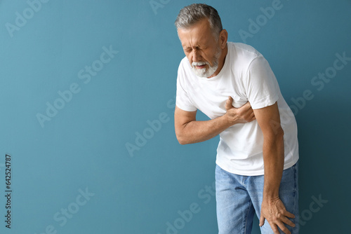 Mature man having heart att...