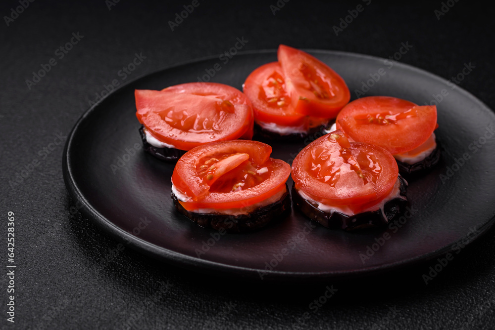 Delicious eggplant cut into circles grilled and cooked with mayonnaise and tomatoes Delicious eggplant cut into circles grilled and cooked with mayonnaise and tomatoes