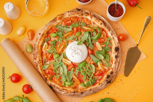 Tasty pizza with Burrata cheese on orange background