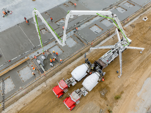 concrete pumping truck pouring walls of warehouse for tilt-up building photo