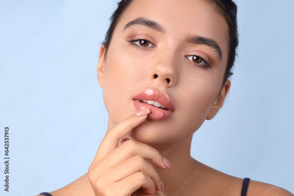 Young woman with beautiful lips on blue background, closeup - obrazy, fototapety, plakaty 