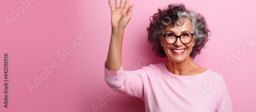 Smiling woman happily wavin...