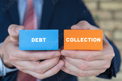 Canvas Print Businessman holding colorful blocks with inscription: DEBT COLLECTION