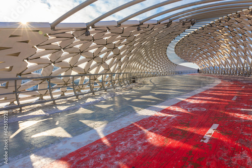 Modern architectural urbanistic Atyrau fish bridge across Ishim river. Pedestrian bridge with graceful fish scales interior, Nur-Sultan, Astana, Kazakhstan. High quality photo photo