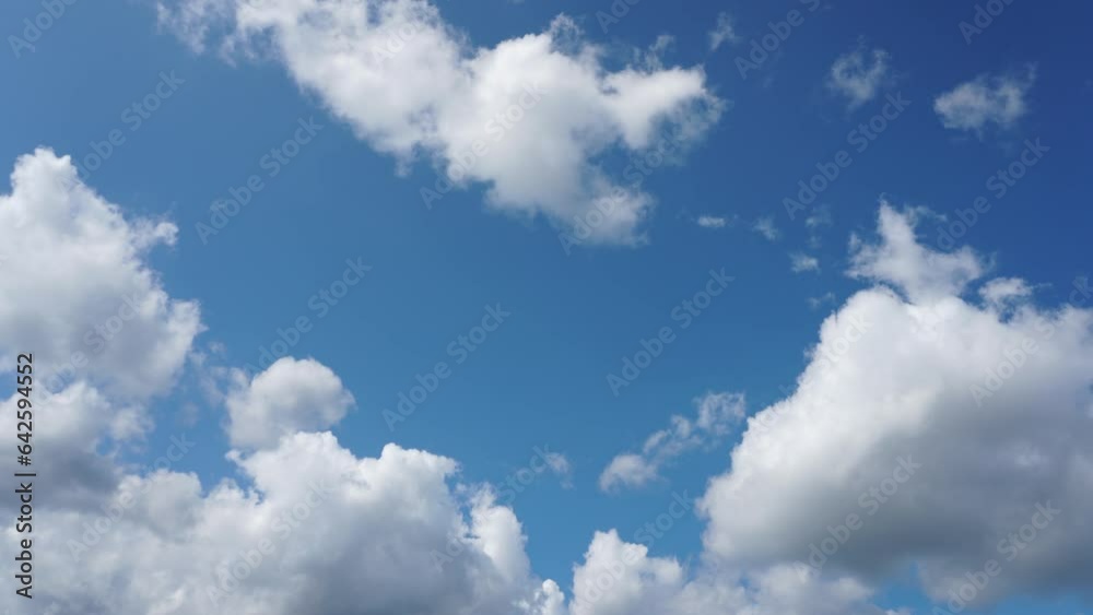 A timelapse of the movement of clouds against the blue sky on a warm summer day. View of the sky and slowly floating fluffy clouds. Climate change, the impact of climate weapons on nature. A timelapse of the movement of clouds against the blue sky on a warm summer day. View of the sky and slowly floating fluffy clouds. Climate change, the impact of climate weapons on nature.