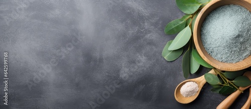 Eucalyptus spa with salt in wooden bowl on gray background
