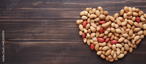 Heart shaped peanuts arranged in a flat lay view with copy space from above