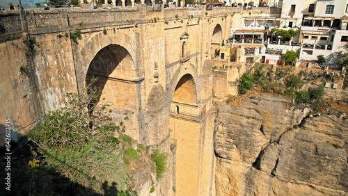 Famous tourist attraction New Bridge Interpretation Center in Ronda, Spain. Beautiful view of Centro de Interpretación del Puente Nuevo with a medieval huge arch bridge carrying the Guadalevín River