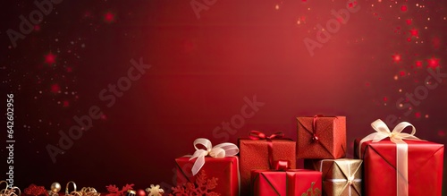 Red background decorated with gift boxes and ornaments Festive backdrop with space for text