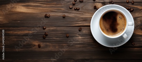 Top view of hot coffee in a white cup on a wooden table