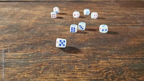 Ordinary dice, ordinary dice falling in super slow motian over rough surface, selective focus. photo