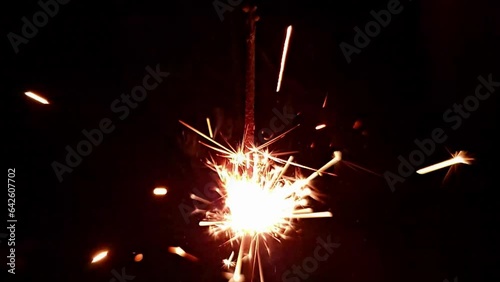 Sparkler candle, beautiful details of burning birthday candle, black background, 4k.