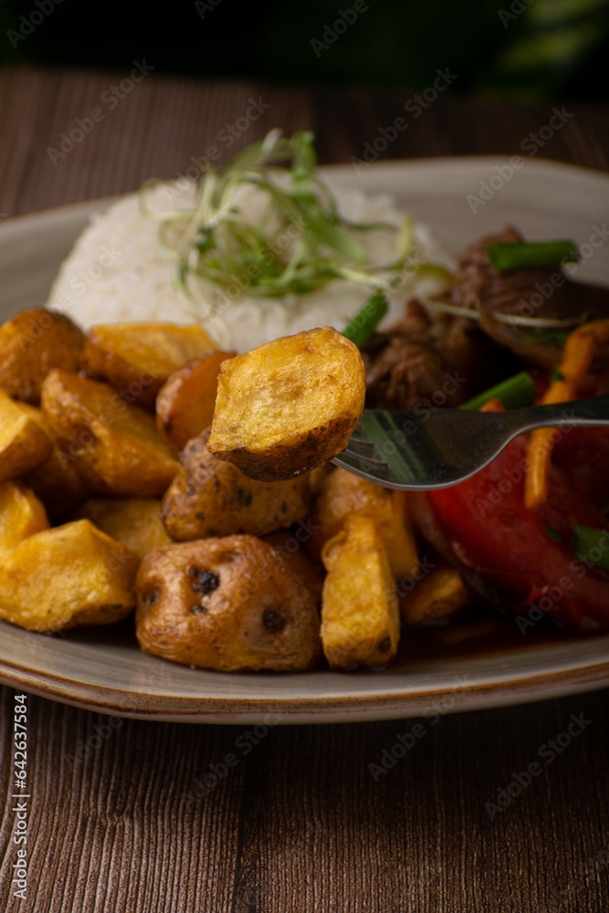 Delicioso plato de lomo saltado con papas nativas 